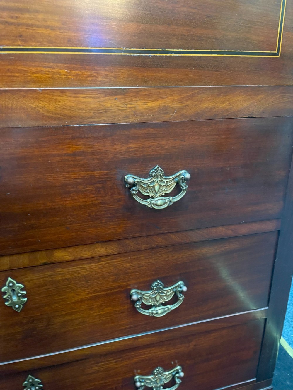 A tall Georgian mahogany secretaire chest featuring stepped upper cabinets with oval satinwood inlay, a pull-out writing drawer, and three lower drawers with brass handles. View XII
