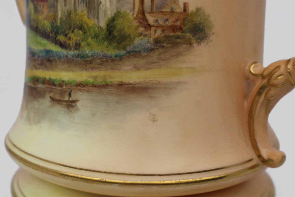 An Edwardian Royal Worcester porcelain loving cup featuring twin gilded scroll handles, a cream blush ground, hand-painted floral motifs, and a central gilt monogram. View XV