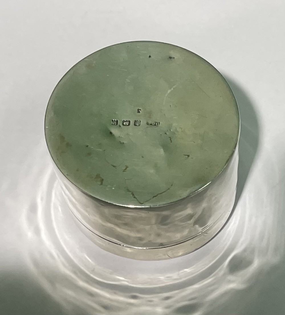 A circular Edwardian silver box lid featuring a blue engine-turned guilloche enamel centre surrounded by a white enamel border with green foliage and dark grape motifs. View VII