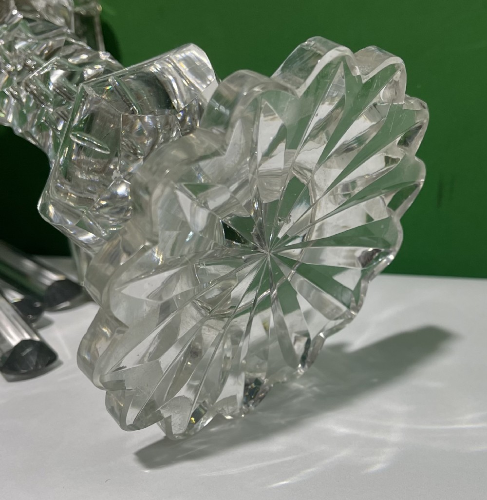 A pair of clear cut glass table lustres featuring faceted stems, starburst cut bases, and hanging crystal prism drops suspended from wire hooks. View XIV