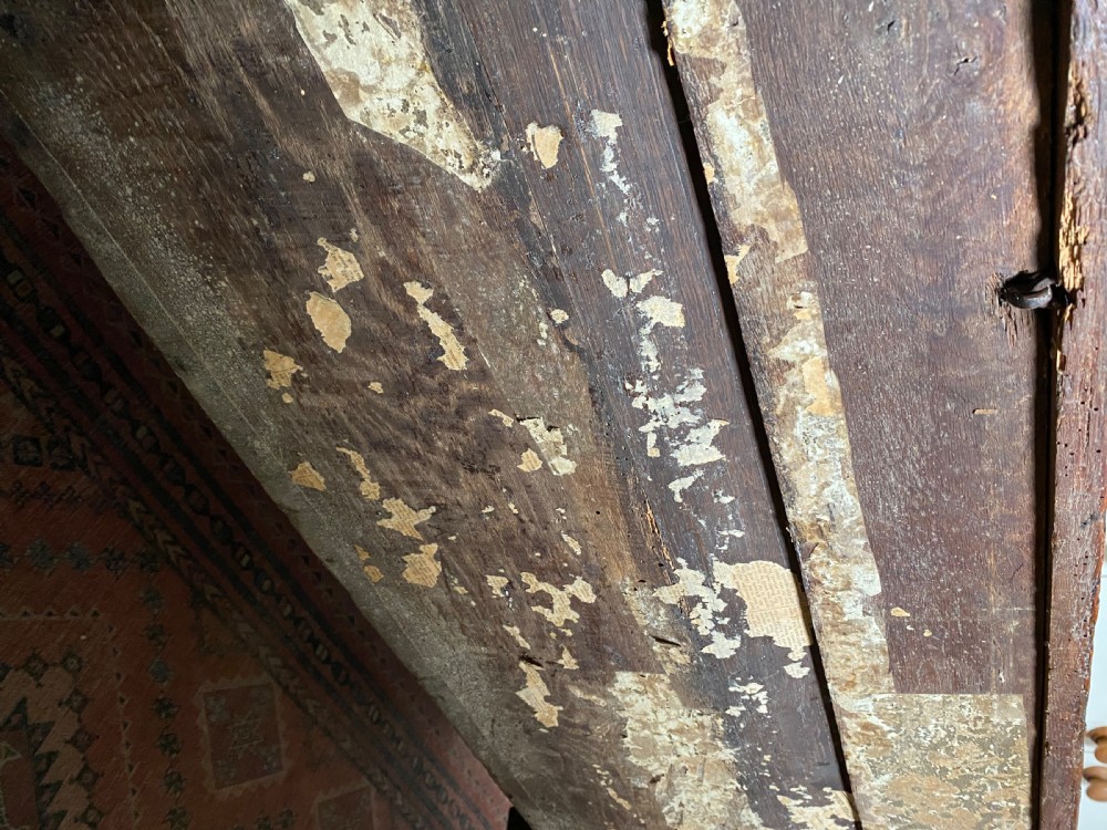 A 17th-century oak coffer displaying hand-carved lunette motifs across the front panel and an iron lockplate. View XI