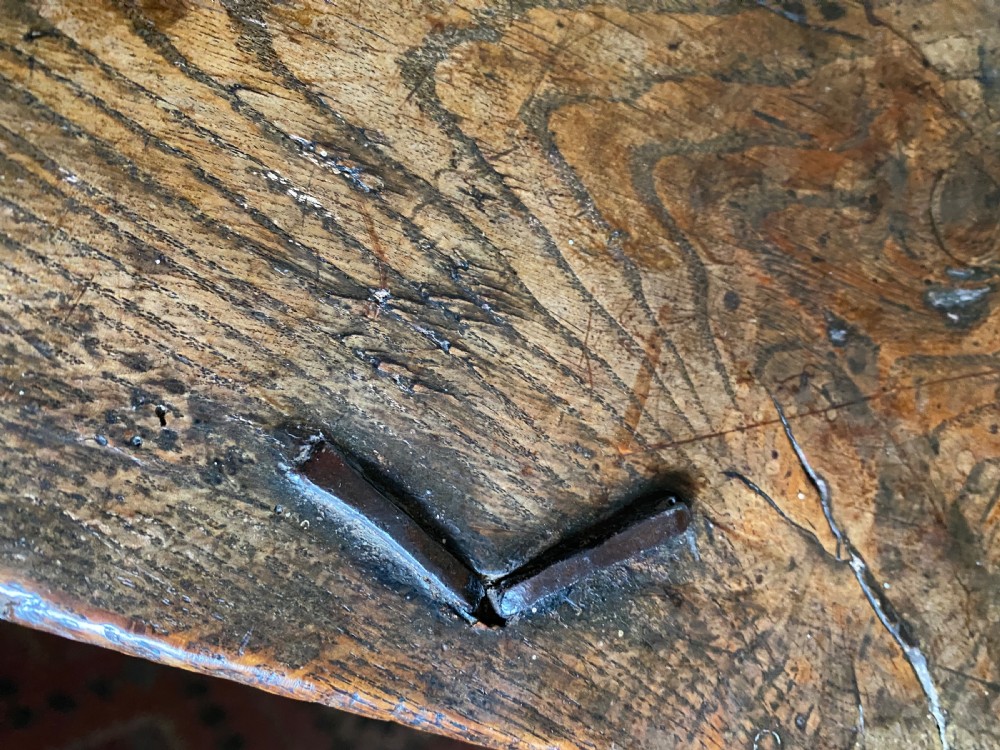 A 17th-century oak coffer displaying hand-carved lunette motifs across the front panel and an iron lockplate. View XII