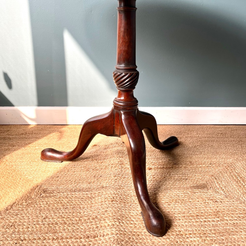 A Georgian mahogany tilt-top tripod table featuring a circular top, turned stem with a spiral carved knop, and three cabriole legs with pad feet. View III