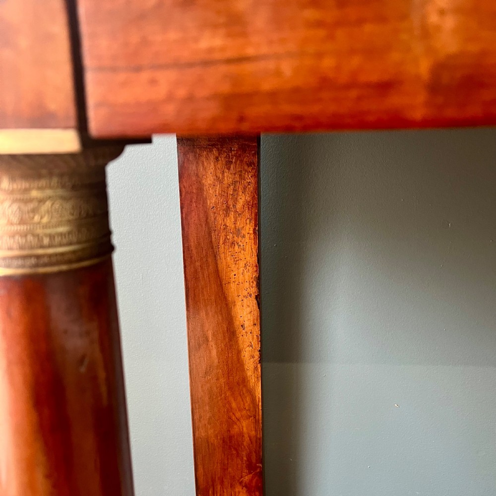 A 19th-century French walnut console table featuring a grey variegated marble top, single frieze drawer, and column legs on a plinth base. View X
