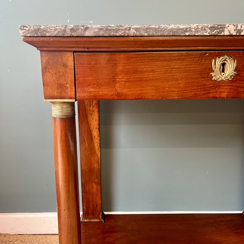 A 19th-century French walnut console table featuring a grey variegated marble top, single frieze drawer, and column legs on a plinth base. View XIII