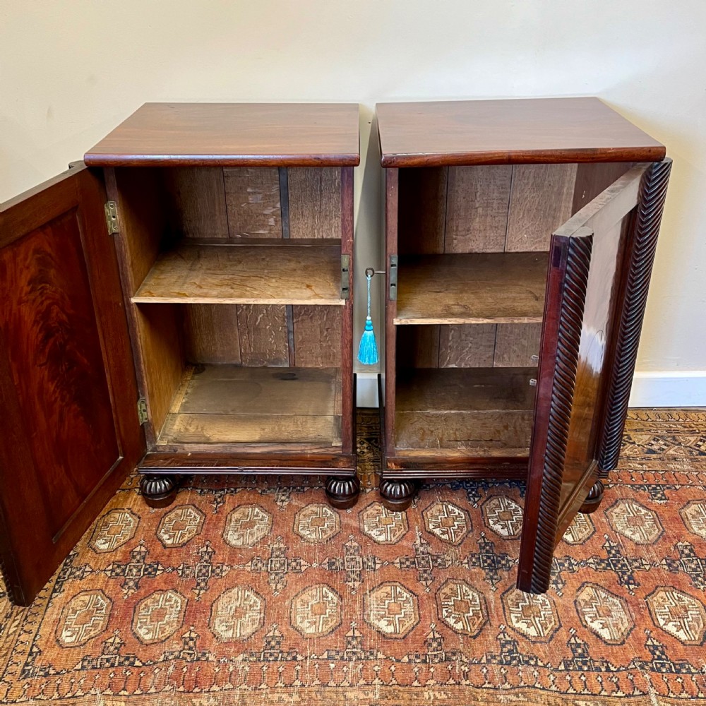 A pair of 19th-century mahogany bedside cupboards featuring flame mahogany panel doors, rope-twist carved side details, and turned feet. View III