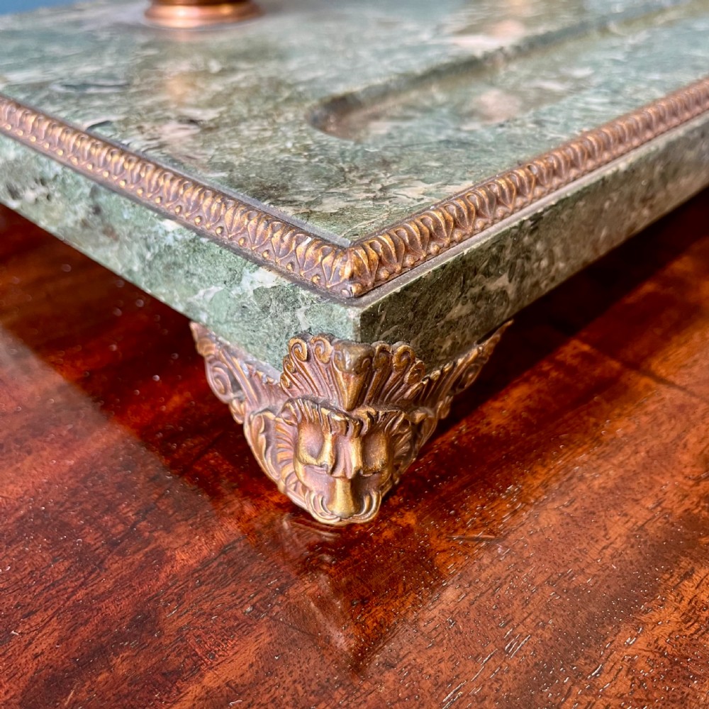 A French green marble desk set featuring a rectangular inkstand base with two raised gilt ormolu inkwells, a carved pen tray, ornate corner feet, and a matching marble rocking blotter. View VIII