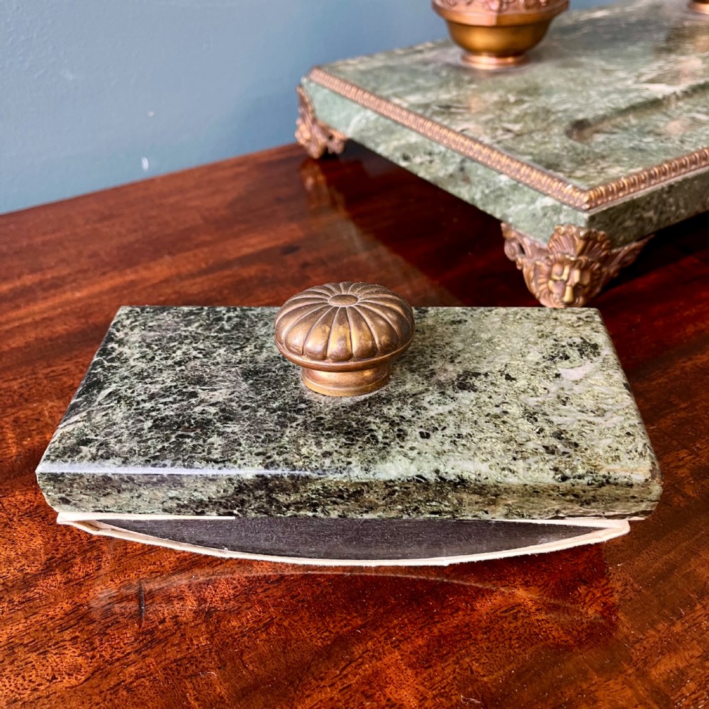 A French green marble desk set featuring a rectangular inkstand base with two raised gilt ormolu inkwells, a carved pen tray, ornate corner feet, and a matching marble rocking blotter. View IX