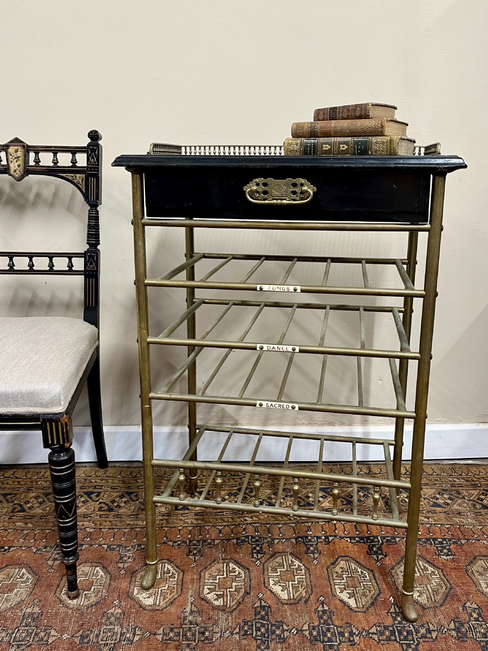 19th century ebonised and brass sheet music stand shelves