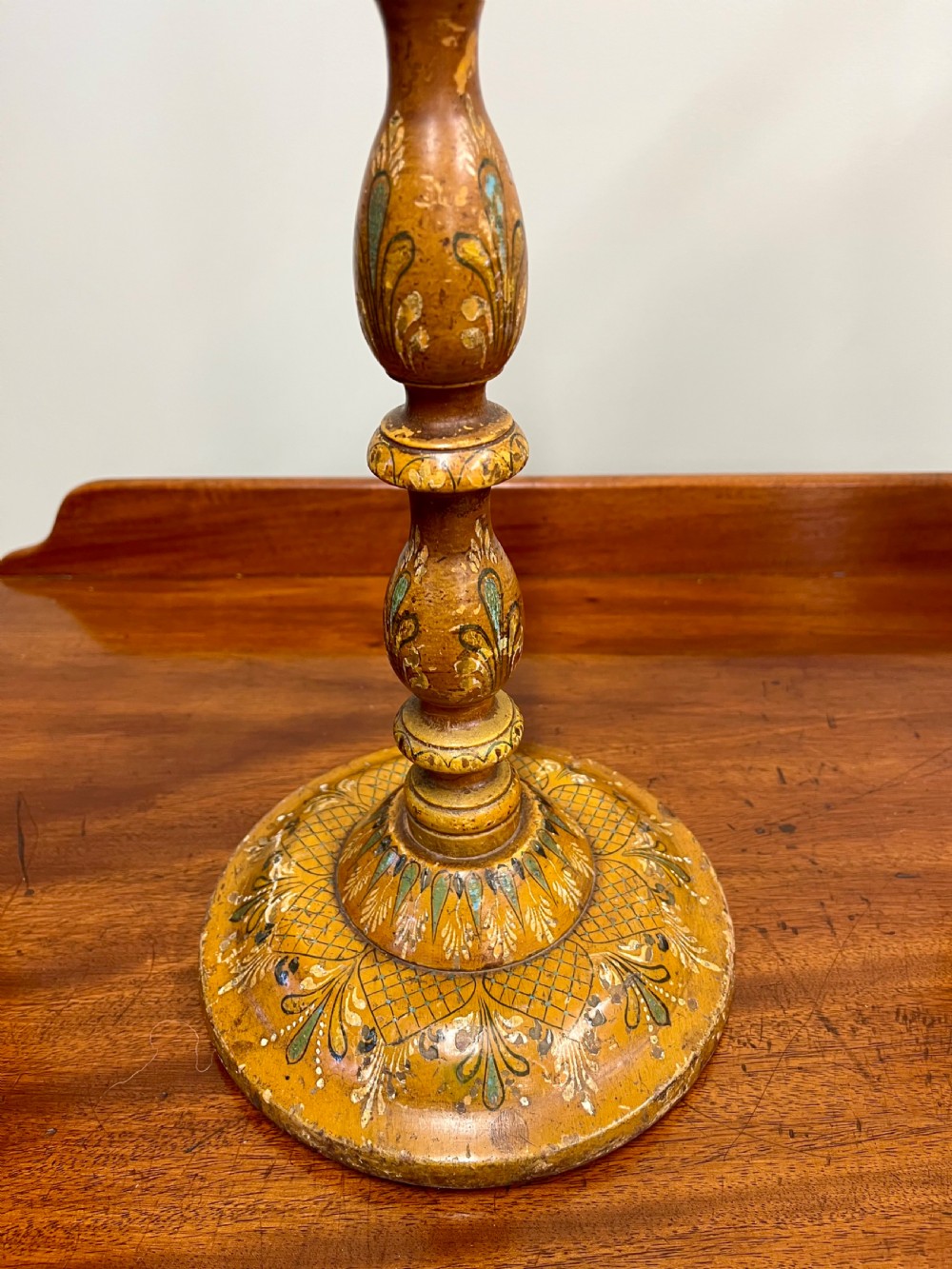 A 19th-century turned wooden Kashmiri table lamp base featuring hand-painted floral motifs in ochre, green, and white with a brass light fitting. View III