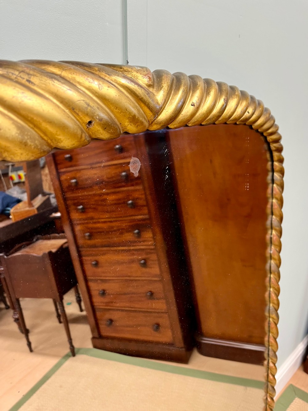 A 19th-century arched overmantel mirror with a gold gilded rope-twist frame and scrolled corner supports. View V