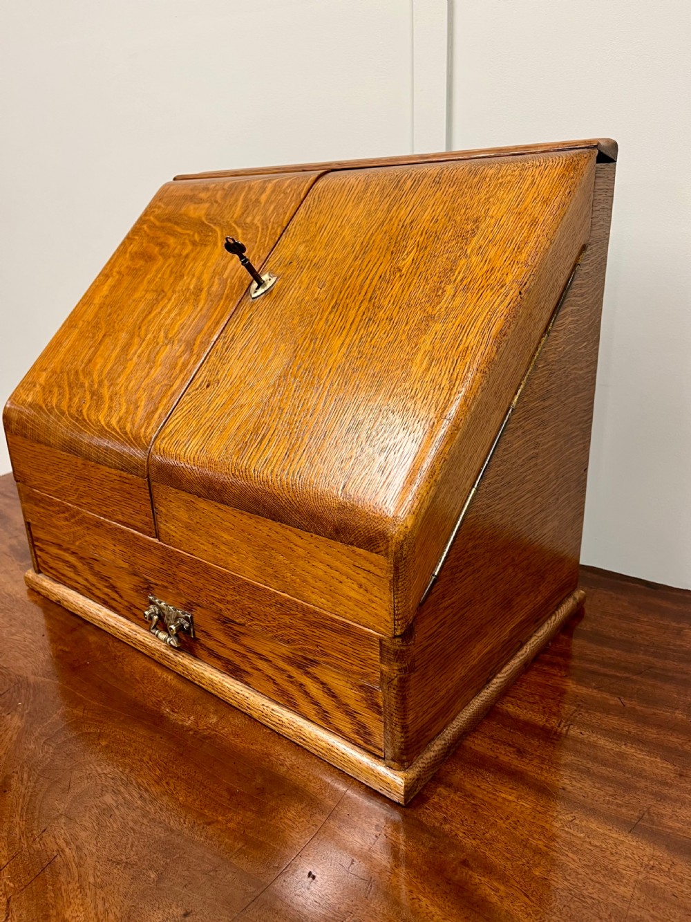 A Victorian oak stationery cabinet with open doors showing stepped letter compartments, a built-in calendar mechanism, inkwell slots, and a lower drawer. View III