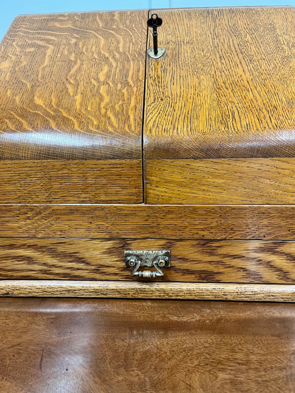 A Victorian oak stationery cabinet with open doors showing stepped letter compartments, a built-in calendar mechanism, inkwell slots, and a lower drawer. View IX