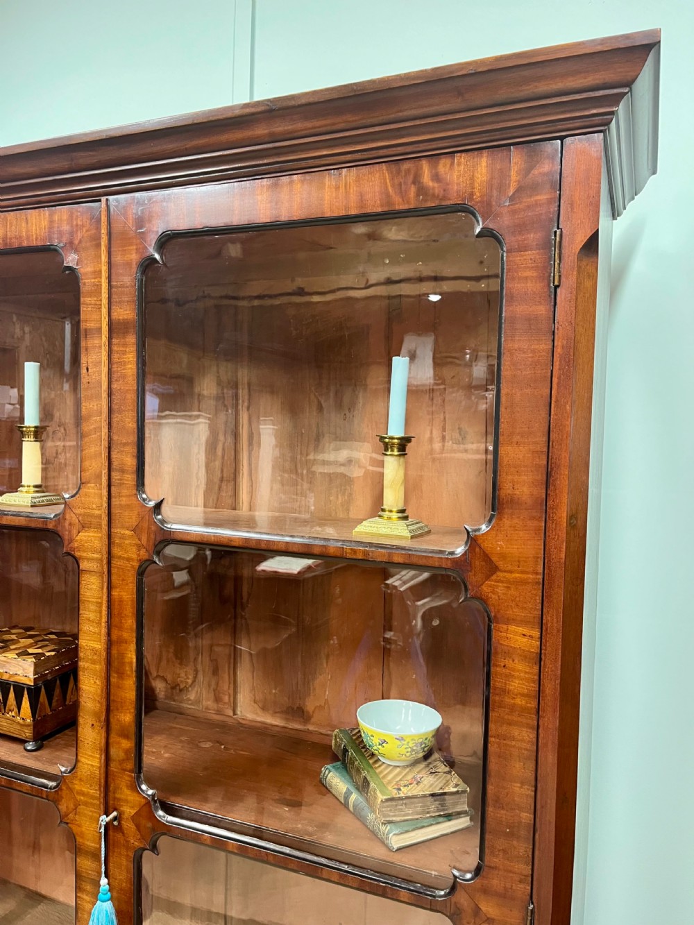 A tall 19th-century mahogany glazed bookcase featuring two double doors with multi-paned glass windows and a moulded top cornice. View II