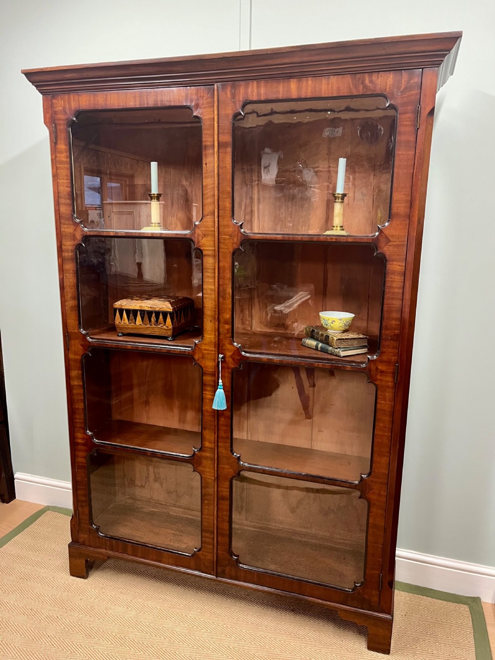 A tall 19th-century mahogany glazed bookcase featuring two double doors with multi-paned glass windows and a moulded top cornice. View V