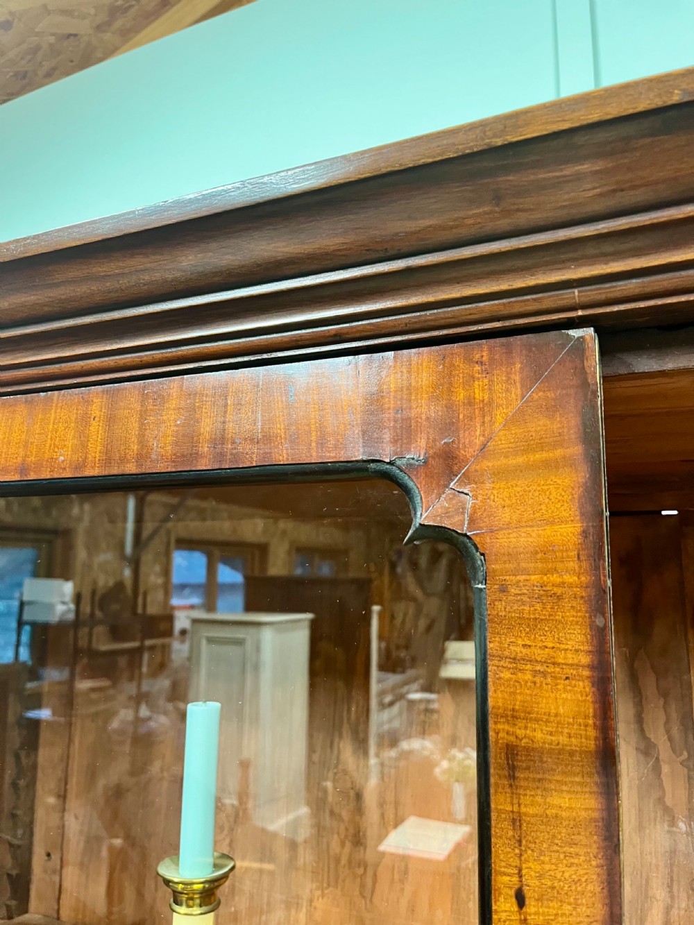 A tall 19th-century mahogany glazed bookcase featuring two double doors with multi-paned glass windows and a moulded top cornice. View X