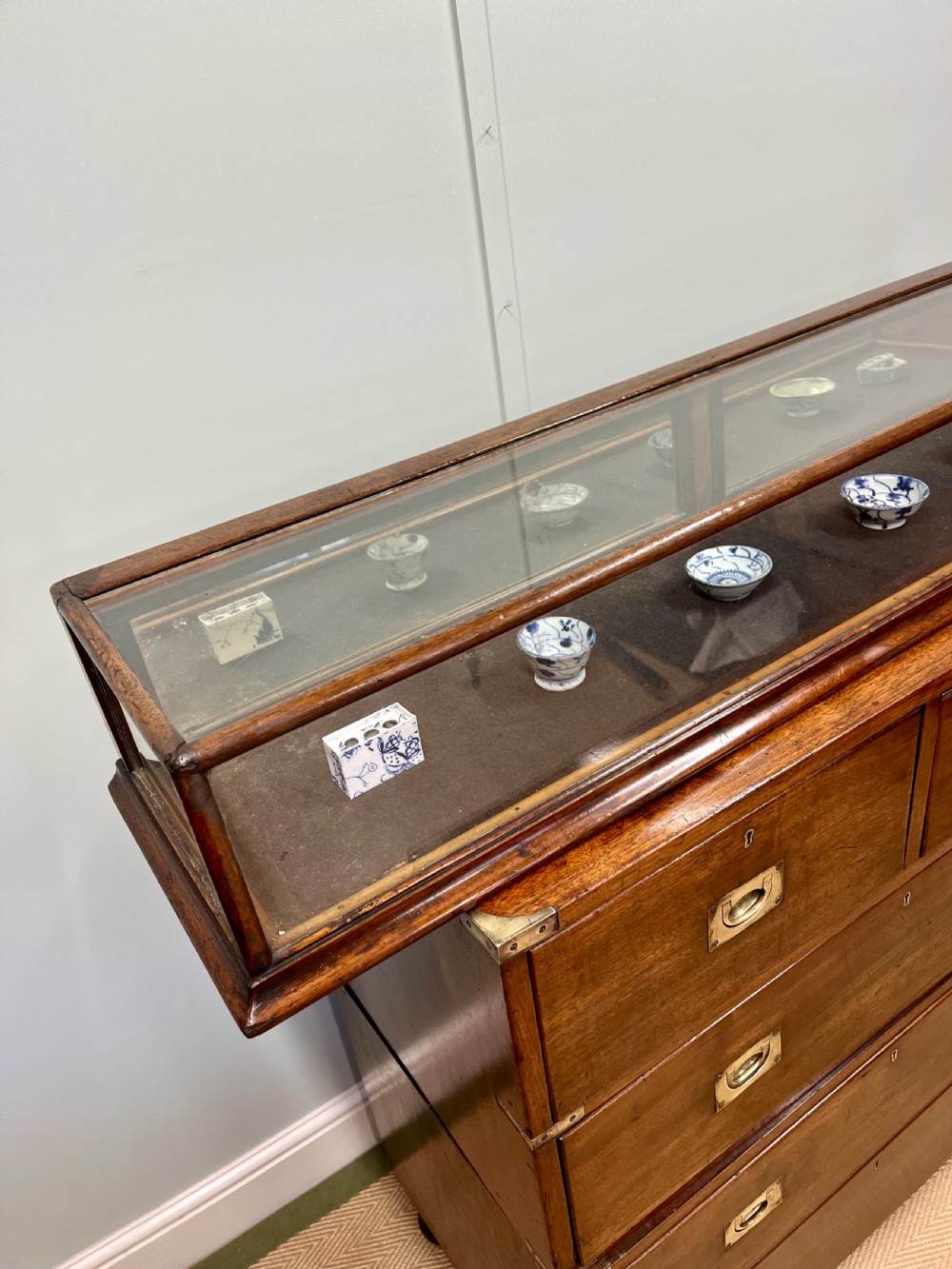 A long, low Victorian mahogany and glass tabletop display case with a moulded base and glazed panels. View III