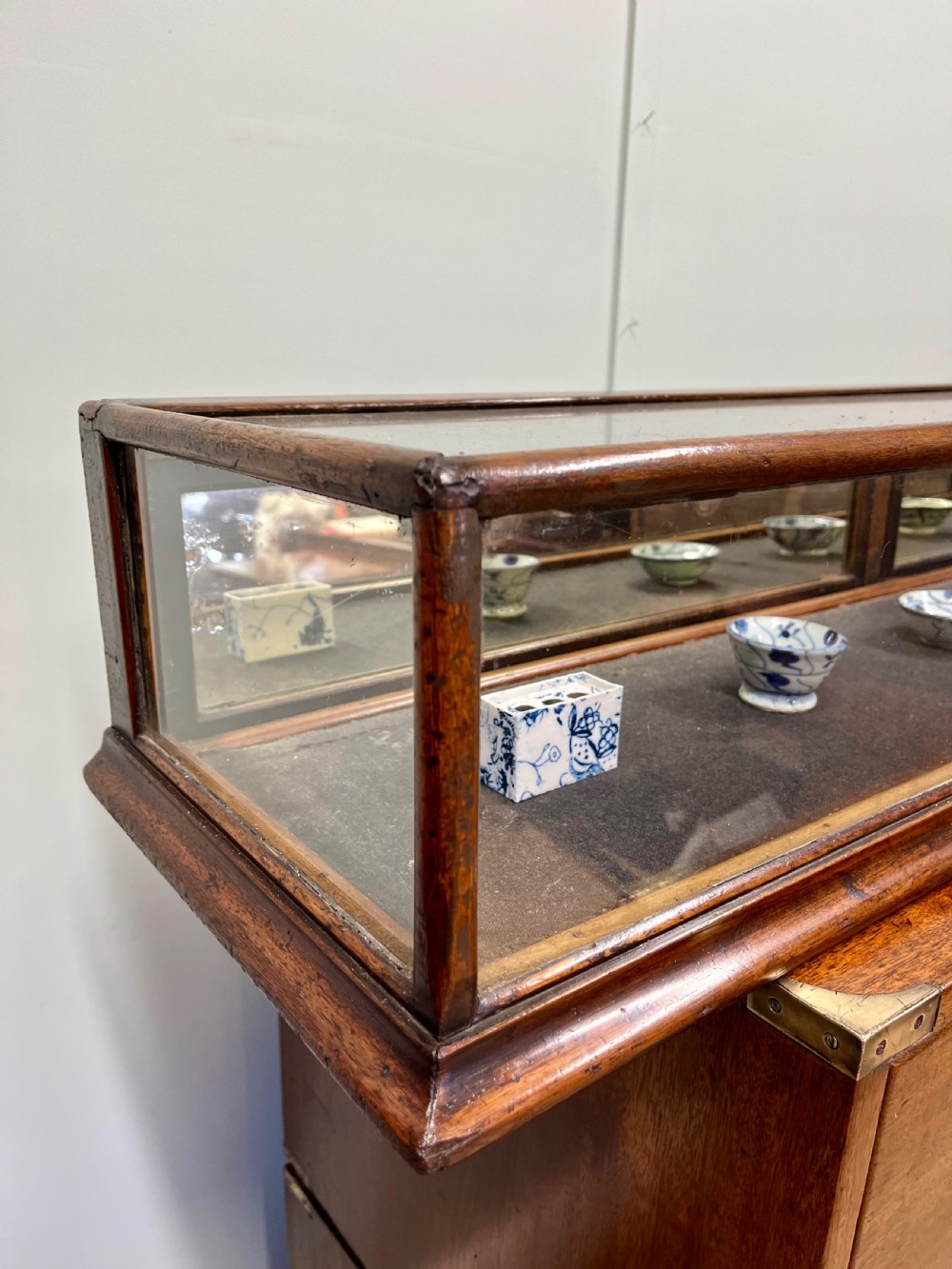 A long, low Victorian mahogany and glass tabletop display case with a moulded base and glazed panels. View V