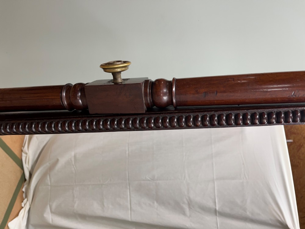 A 19th-century dark mahogany cheval mirror featuring bobbin-moulded edging, turned upright support columns with finials, brass adjusting knobs, and a trestle base with splayed legs. View VI