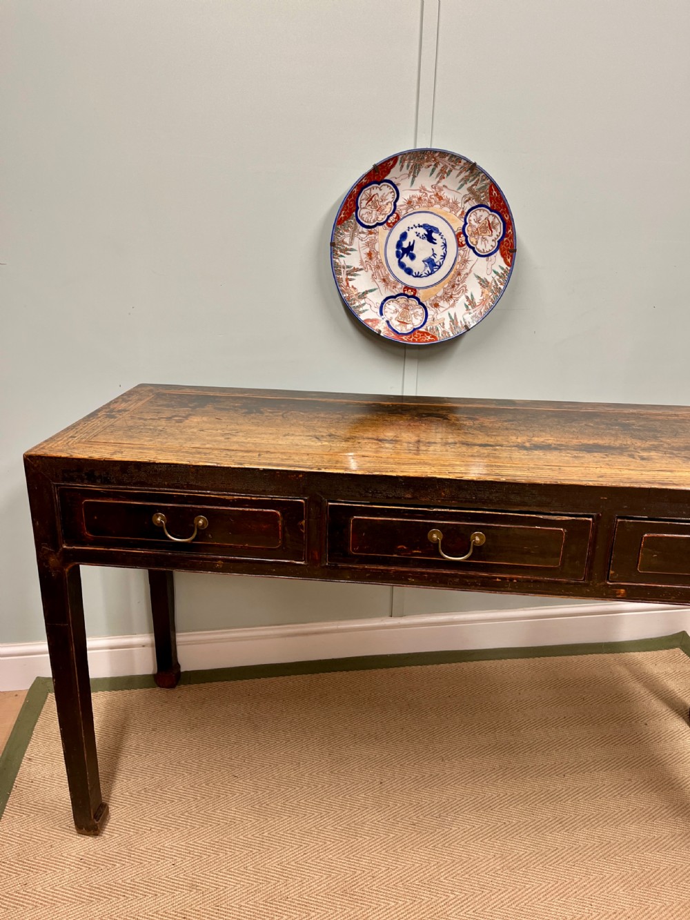 A 19th-century Chinese dark lacquered elm table featuring three drawers with brass drop handles and a long rectangular top. View III