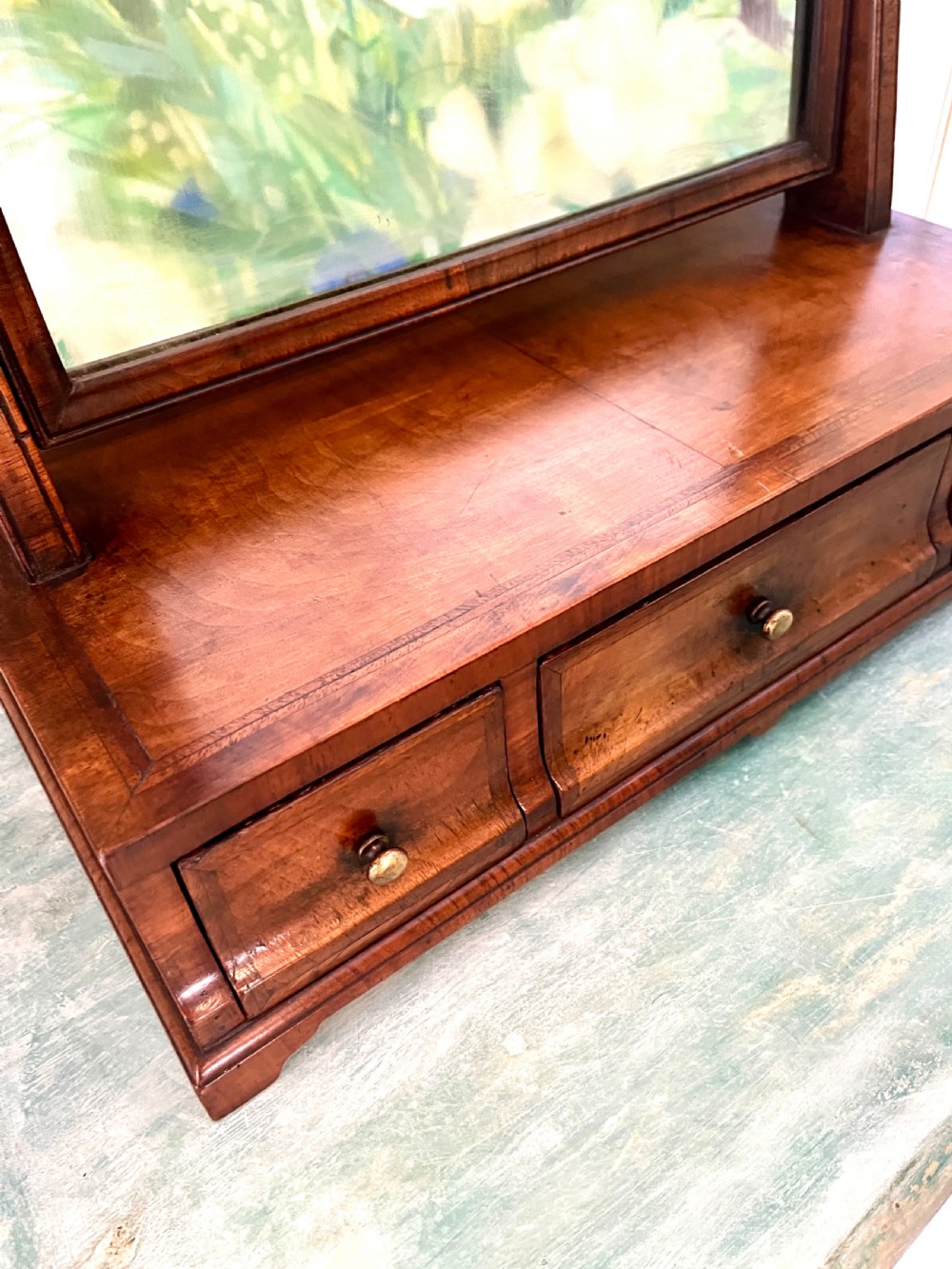 An Edwardian walnut toilet mirror with an arched glass frame held by turned upright posts on a three-drawer plinth base. View VIII