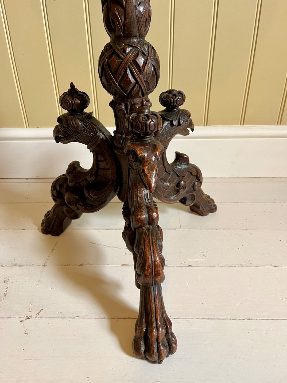 A 19th-century French oak round side table featuring a geometric parquetry top, carved rim, turned column pedestal, and carved tripod feet. View IV