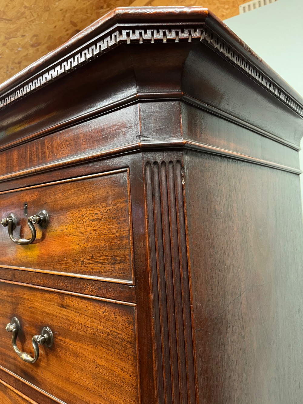 An 18th-century Georgian mahogany chest on chest featuring two short over six long graduated drawers with brass swan-neck handles and ogee bracket feet. View V