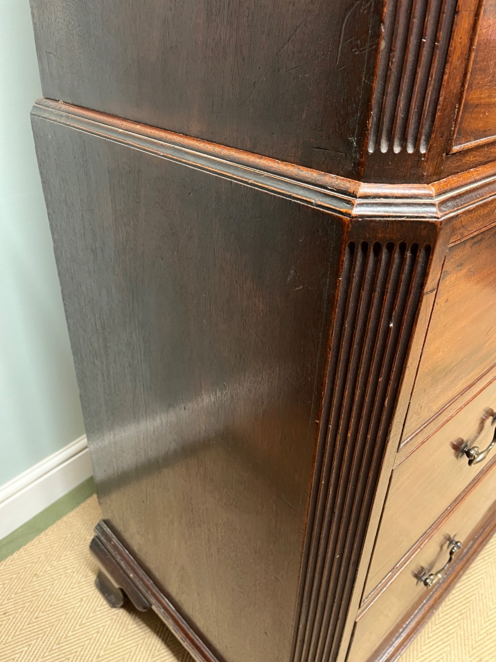 An 18th-century Georgian mahogany chest on chest featuring two short over six long graduated drawers with brass swan-neck handles and ogee bracket feet. View X