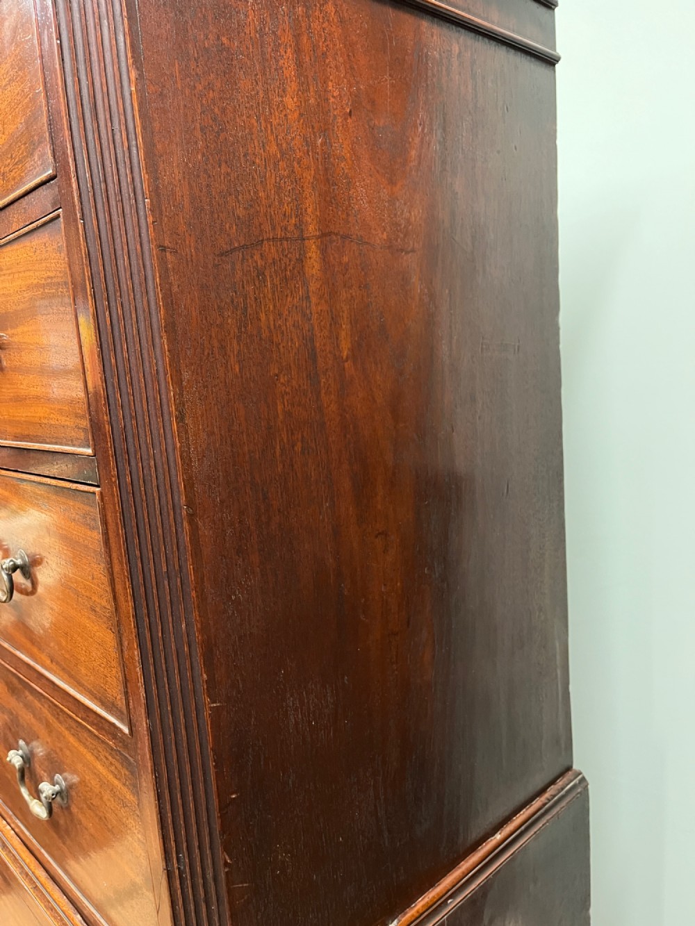 An 18th-century Georgian mahogany chest on chest featuring two short over six long graduated drawers with brass swan-neck handles and ogee bracket feet. View XI
