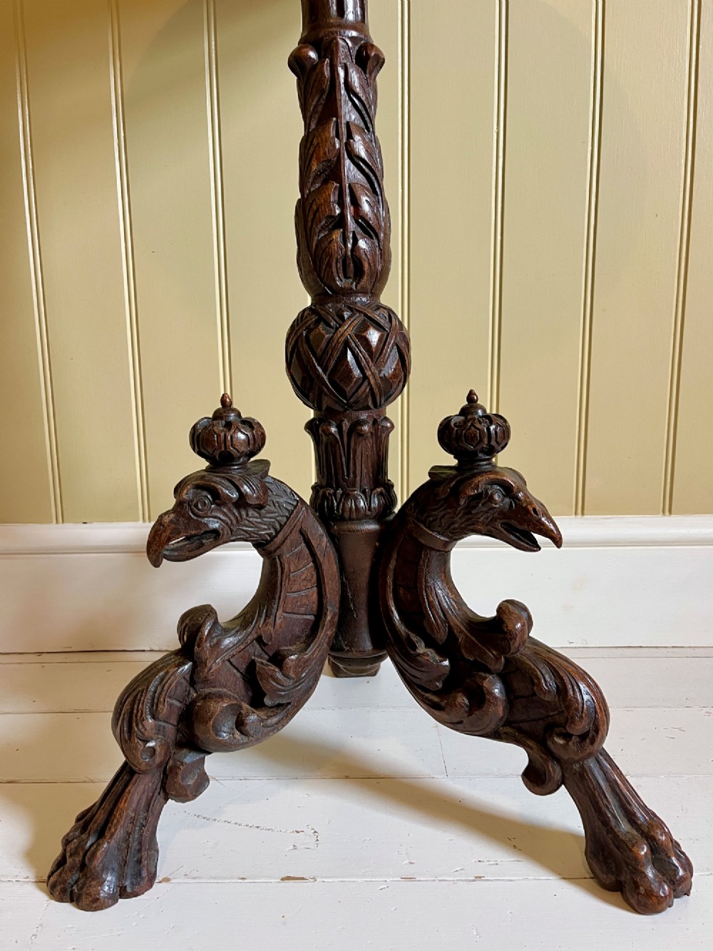 A 19th-century French oak side table with a circular parquetry top, carved gadrooned edge, ornate central column, and carved tripod legs. View IV