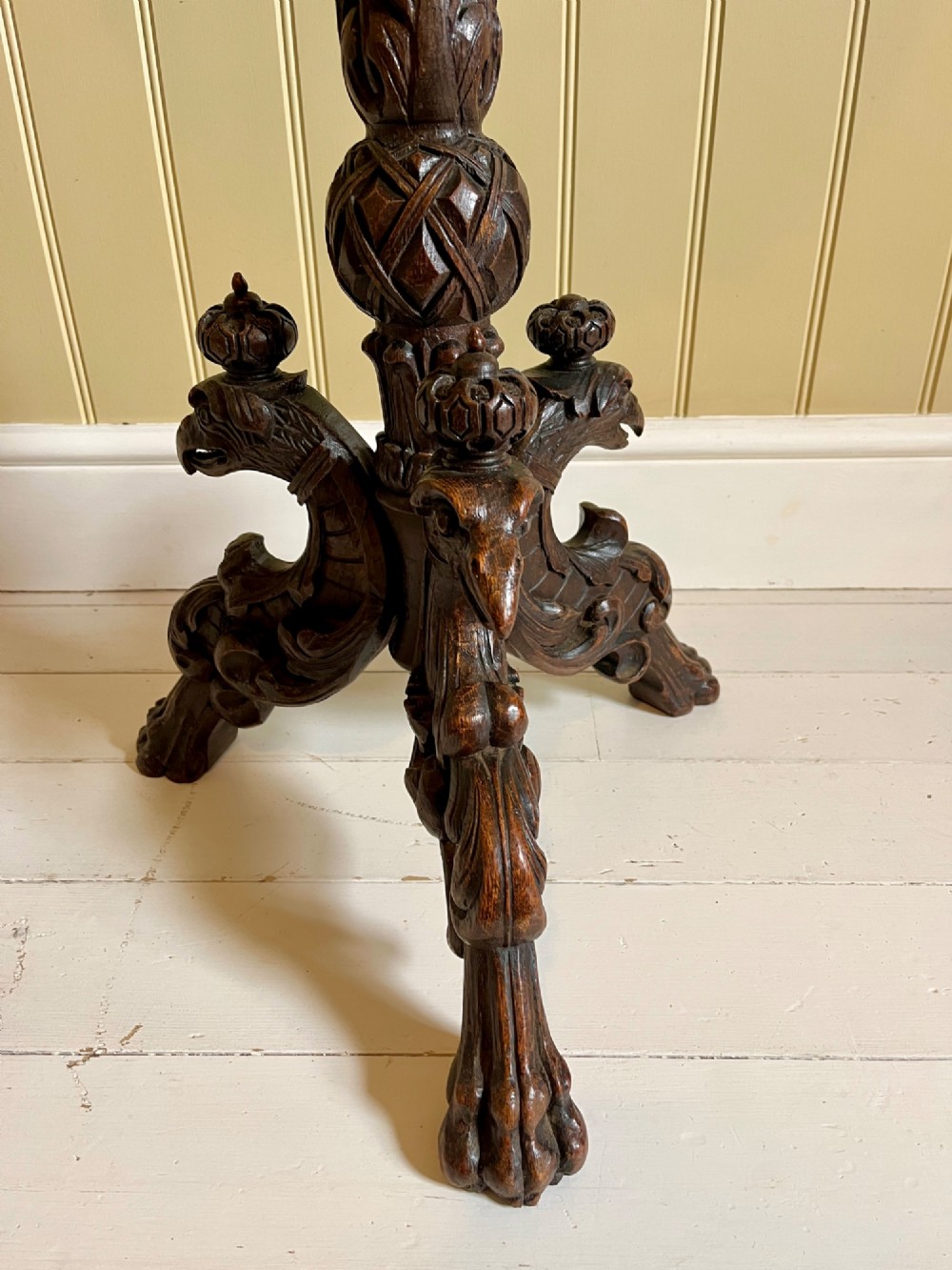 A 19th-century French oak side table with a circular parquetry top, carved gadrooned edge, ornate central column, and carved tripod legs. View V