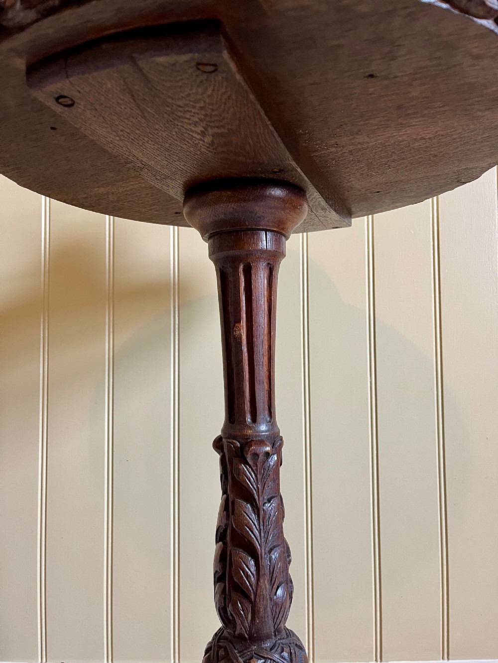 A 19th-century French oak side table with a circular parquetry top, carved gadrooned edge, ornate central column, and carved tripod legs. View VII