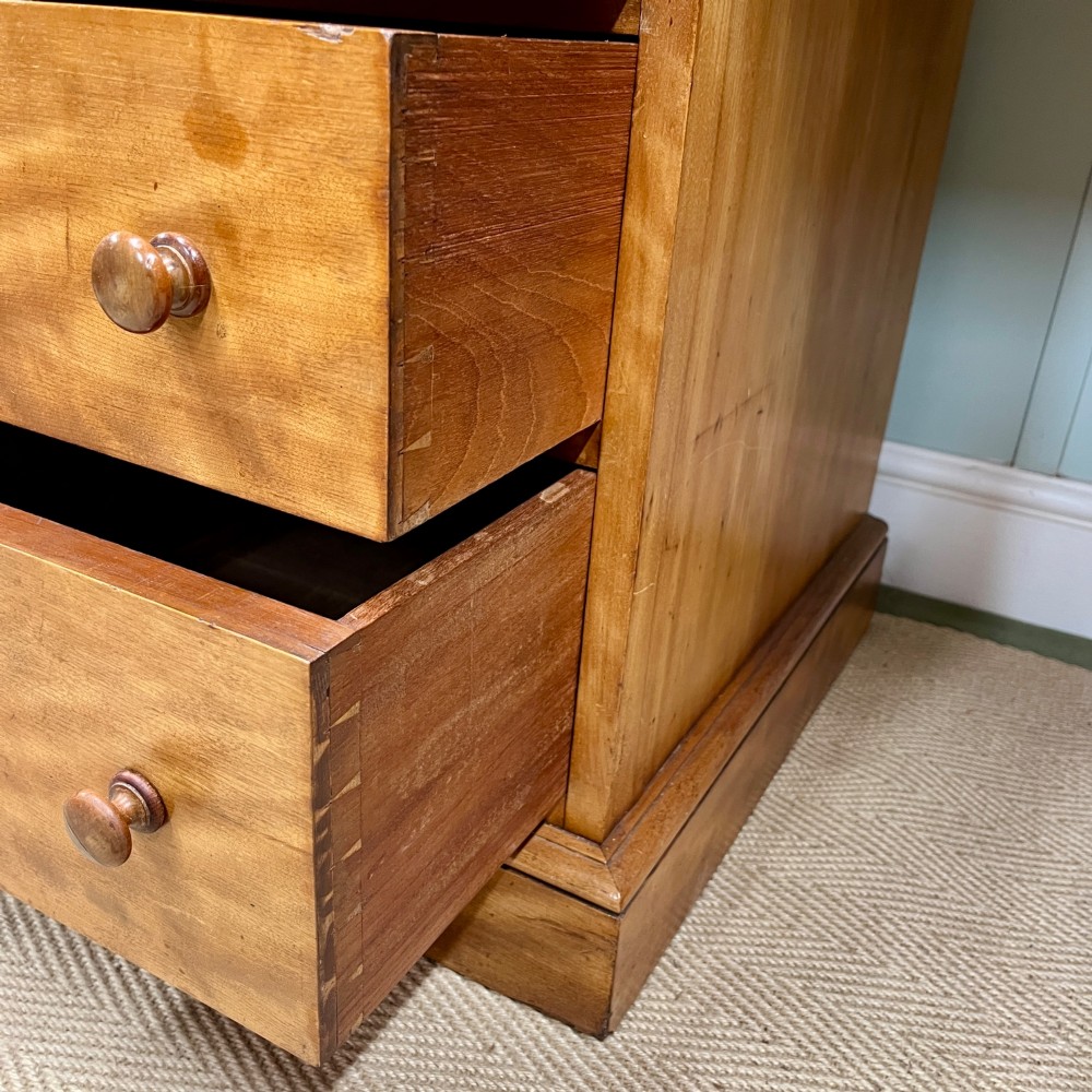 A 19th-century satin birch twin-pedestal desk featuring nine drawers with turned wooden knobs and a low gallery back. View VI