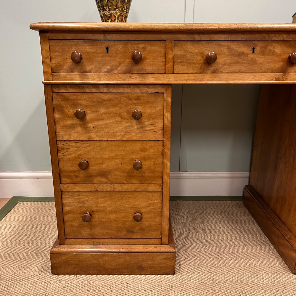 A 19th-century satin birch twin-pedestal desk featuring nine drawers with turned wooden knobs and a low gallery back. View XI