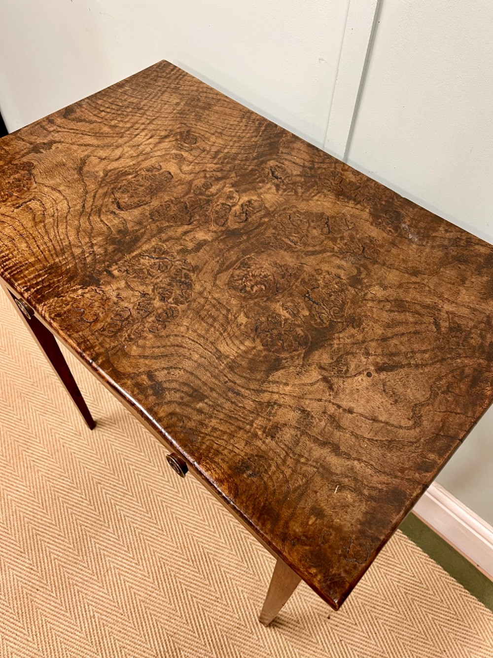 A 19th-century burr ash side table featuring two front drawers with round brass knobs and slender tapered square legs. View III
