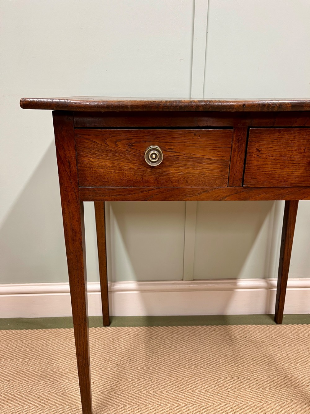 A 19th-century burr ash side table featuring two front drawers with round brass knobs and slender tapered square legs. View IV