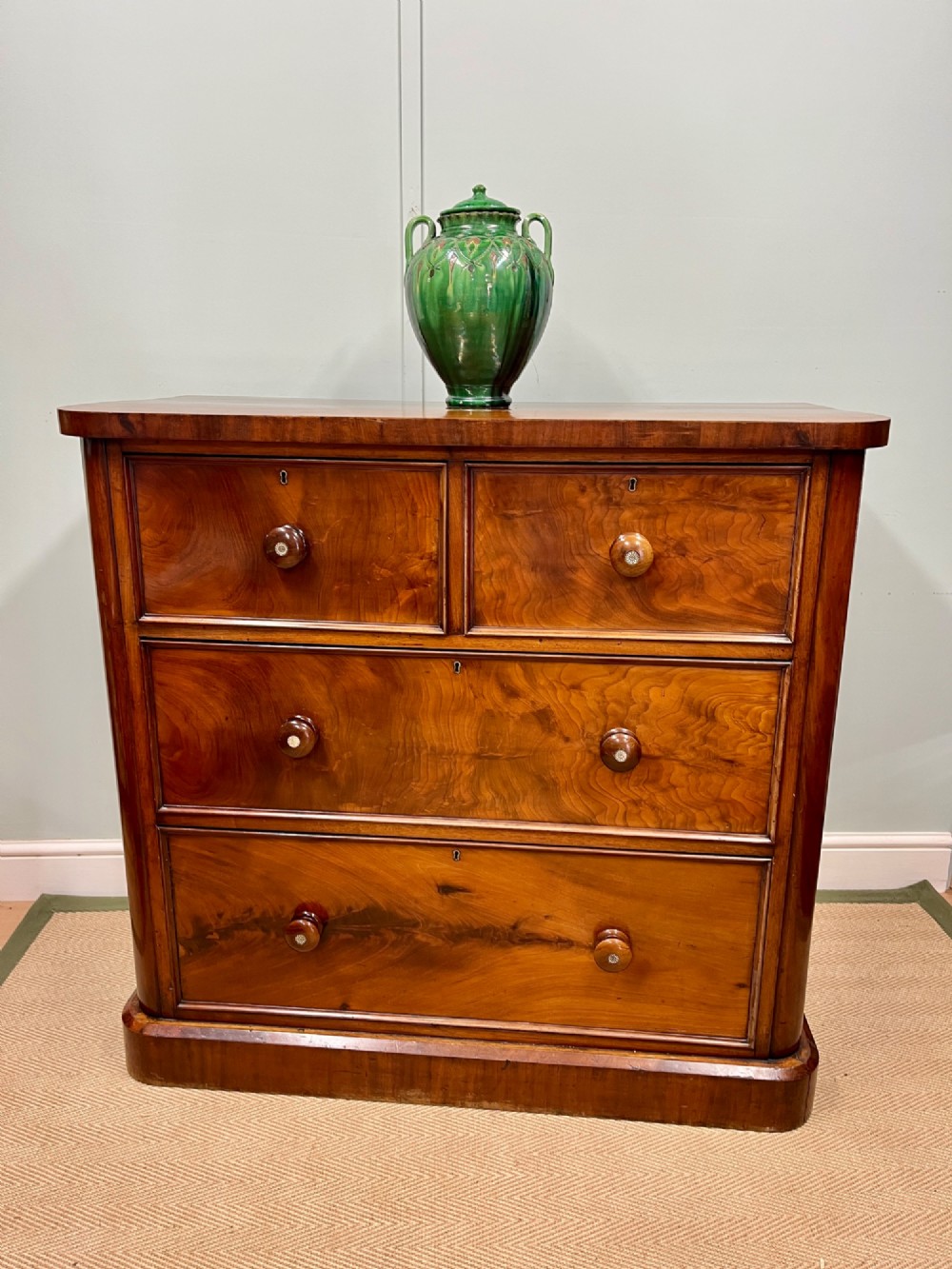 A 19th-century mahogany chest of drawers featuring two short upper drawers above two long lower drawers, set on a solid plinth base.