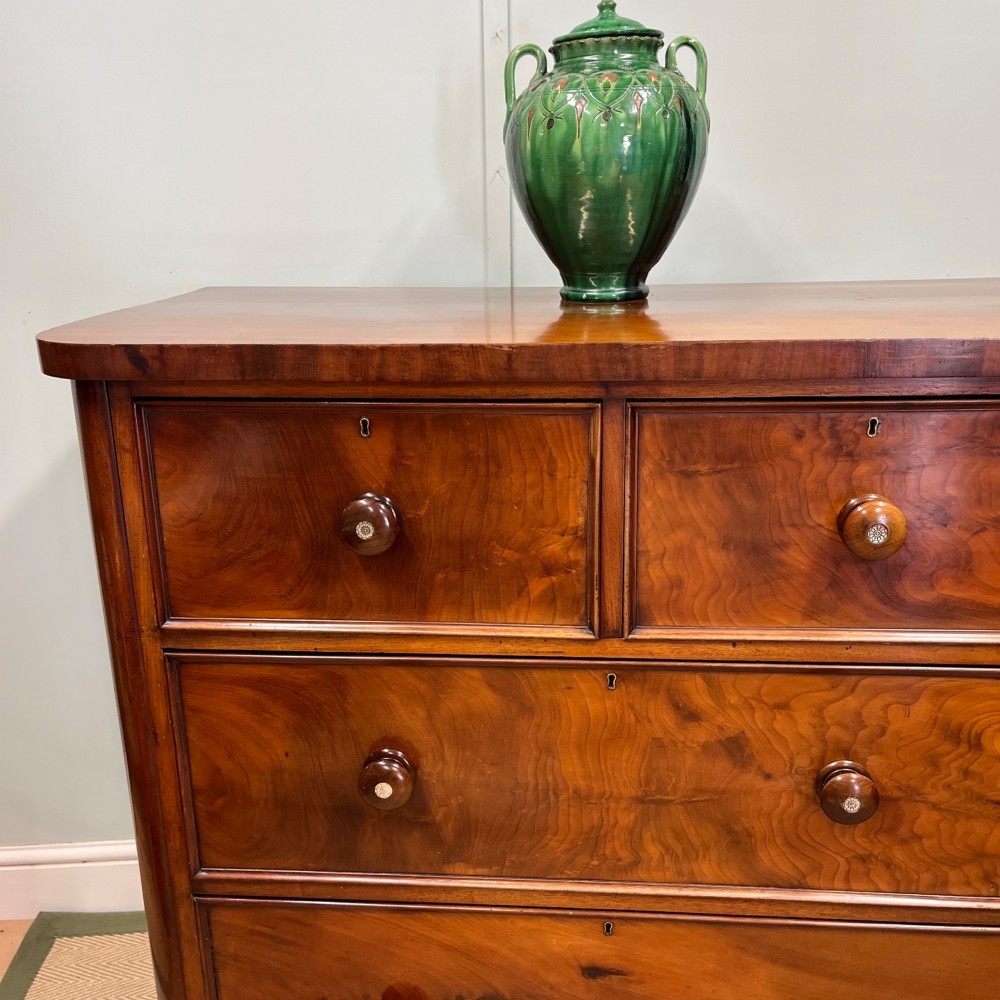 A 19th-century mahogany chest of drawers featuring two short upper drawers above two long lower drawers, set on a solid plinth base. View II