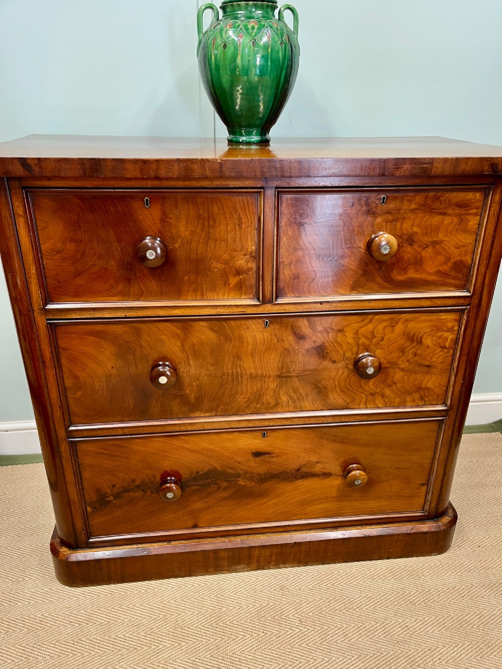 A 19th-century mahogany chest of drawers featuring two short upper drawers above two long lower drawers, set on a solid plinth base. View IV