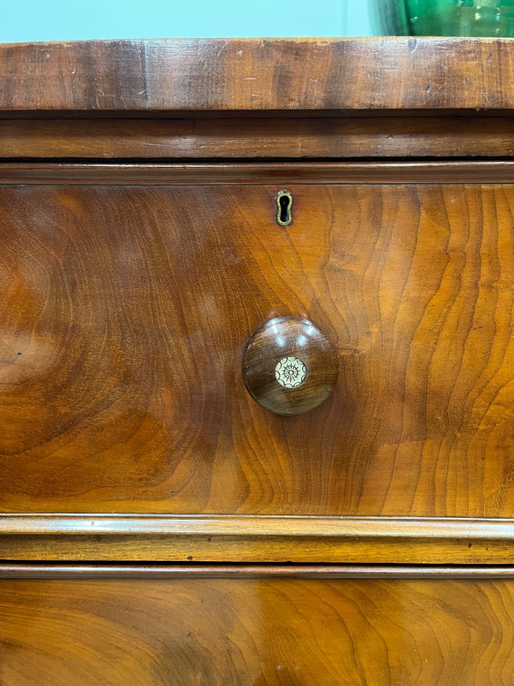A 19th-century mahogany chest of drawers featuring two short upper drawers above two long lower drawers, set on a solid plinth base. View VI