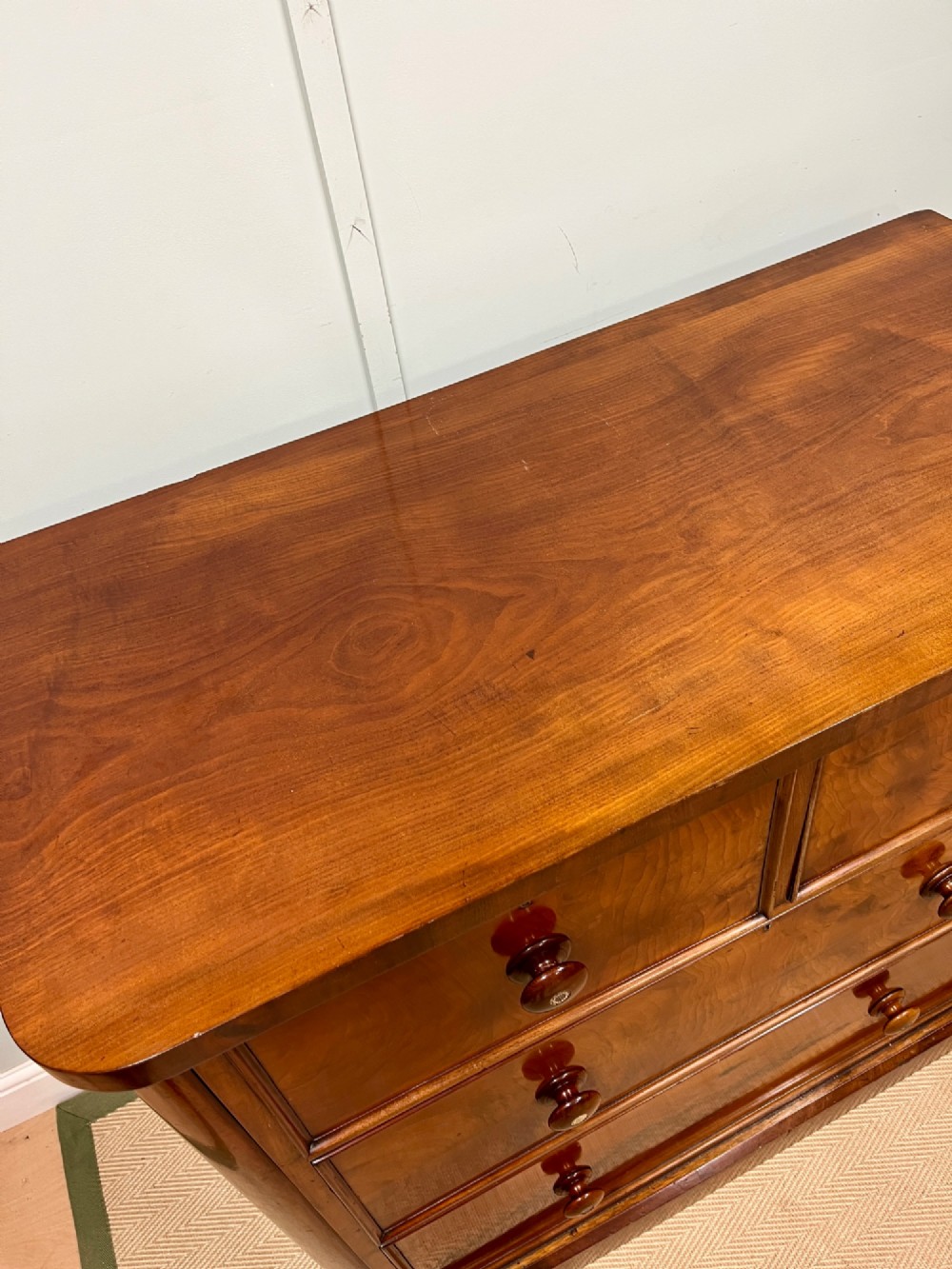 A 19th-century mahogany chest of drawers featuring two short upper drawers above two long lower drawers, set on a solid plinth base. View VII