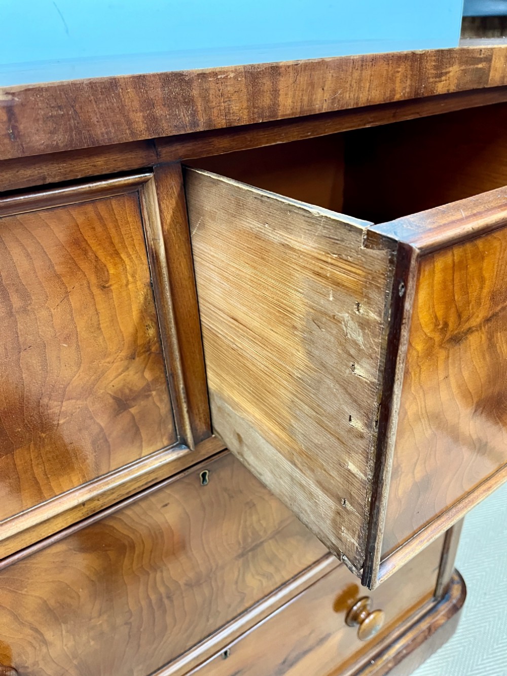 A 19th-century mahogany chest of drawers featuring two short upper drawers above two long lower drawers, set on a solid plinth base. View IX