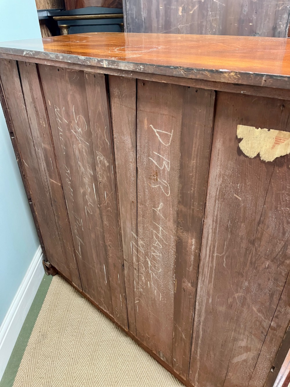 A 19th-century mahogany chest of drawers featuring two short upper drawers above two long lower drawers, set on a solid plinth base. View XI