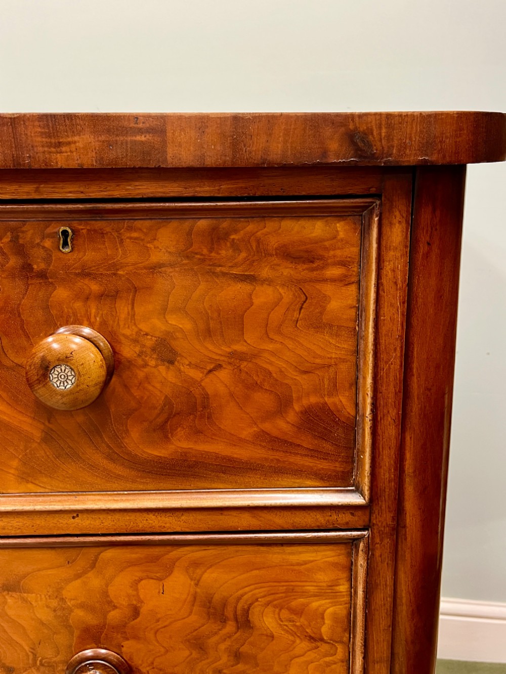 A 19th-century mahogany chest of drawers featuring two short upper drawers above two long lower drawers, set on a solid plinth base. View XII
