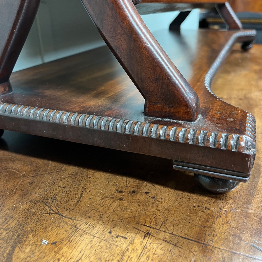 A 19th-century rectangular flame mahogany toilet mirror with a swivelling frame resting on a shaped platform base with carved edging. View IX