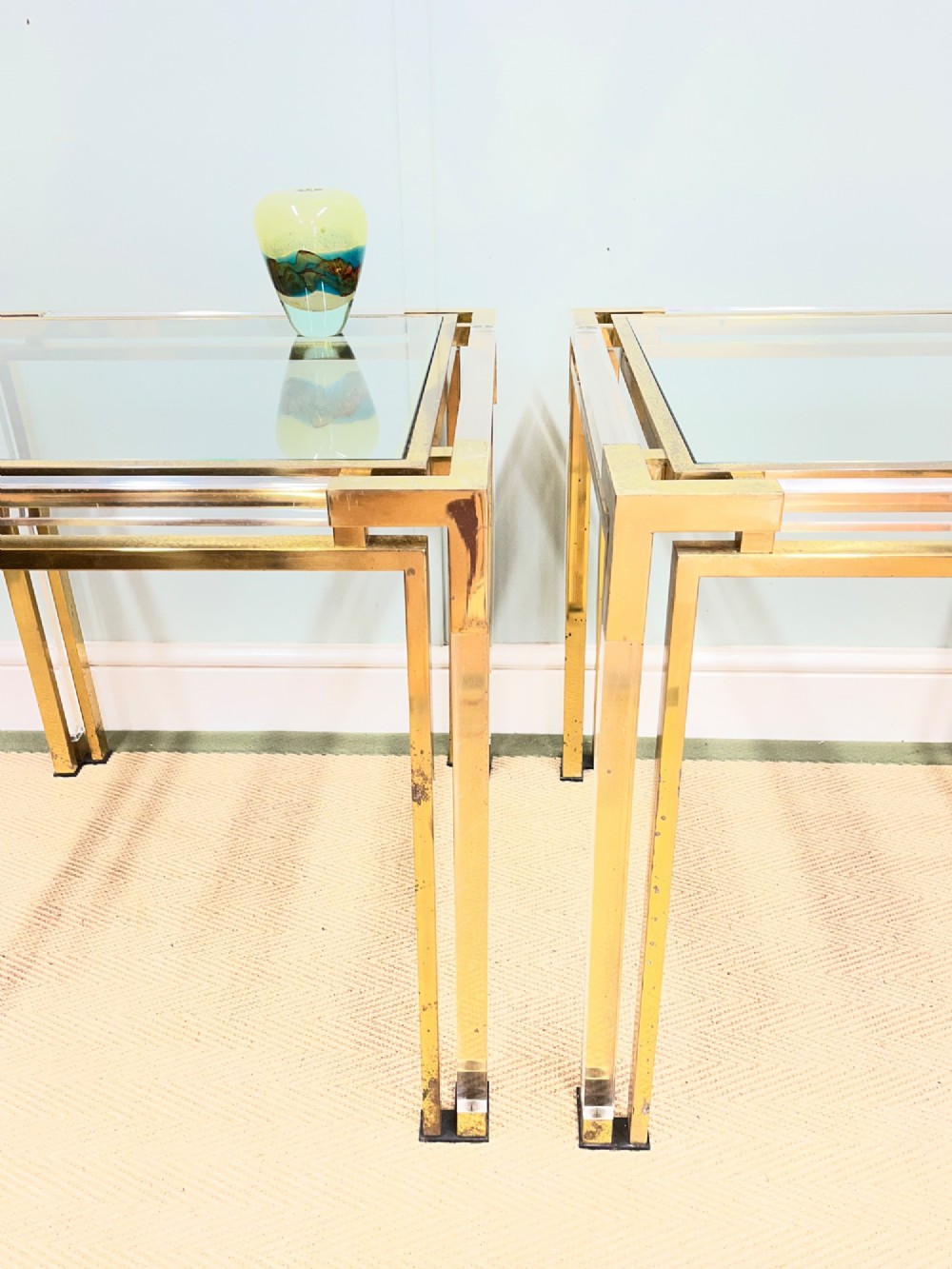 A pair of square side tables featuring brass frames, clear lucite corner inserts, and glass tops. View II