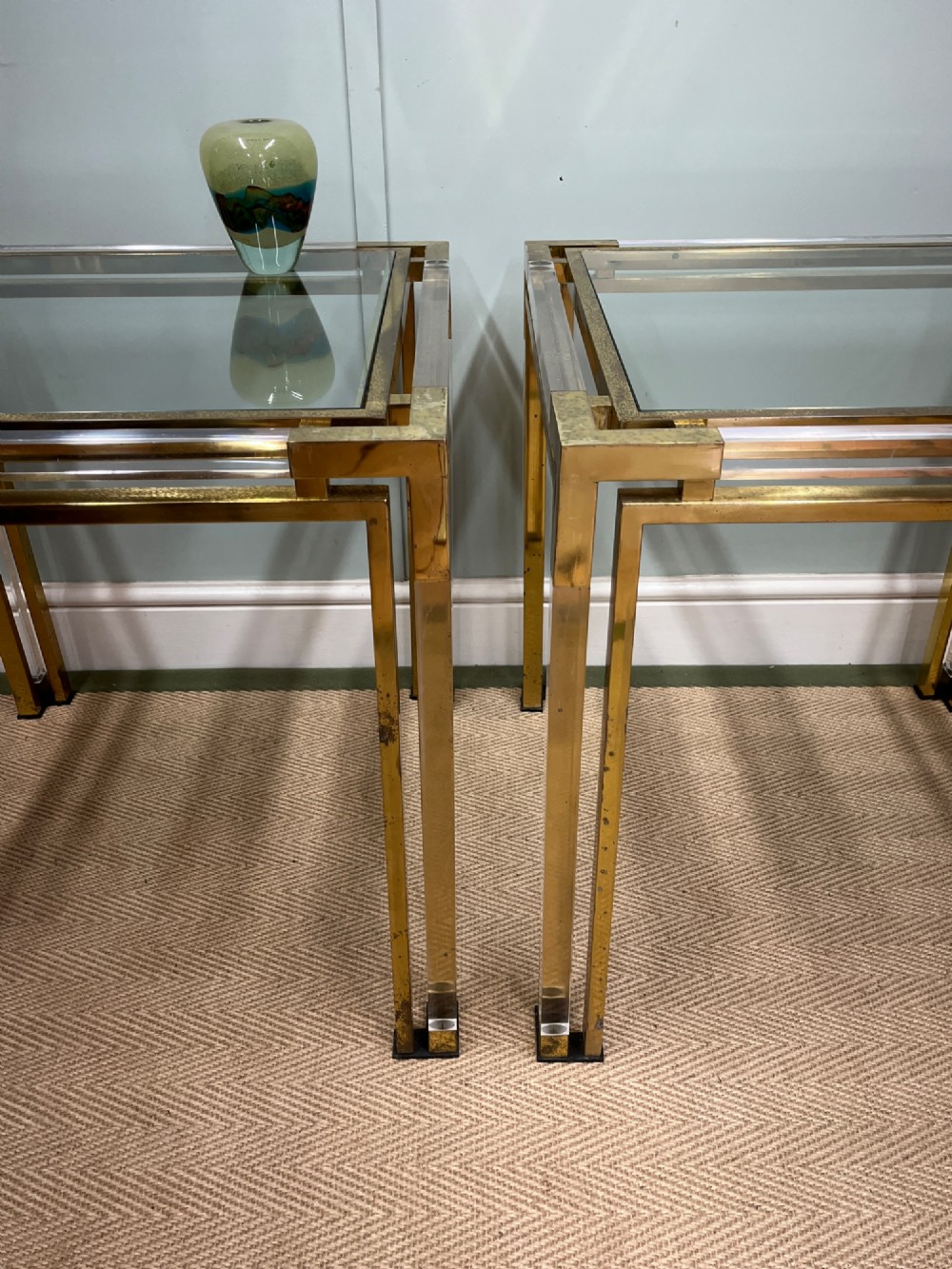 A pair of square side tables featuring brass frames, clear lucite corner inserts, and glass tops. View III