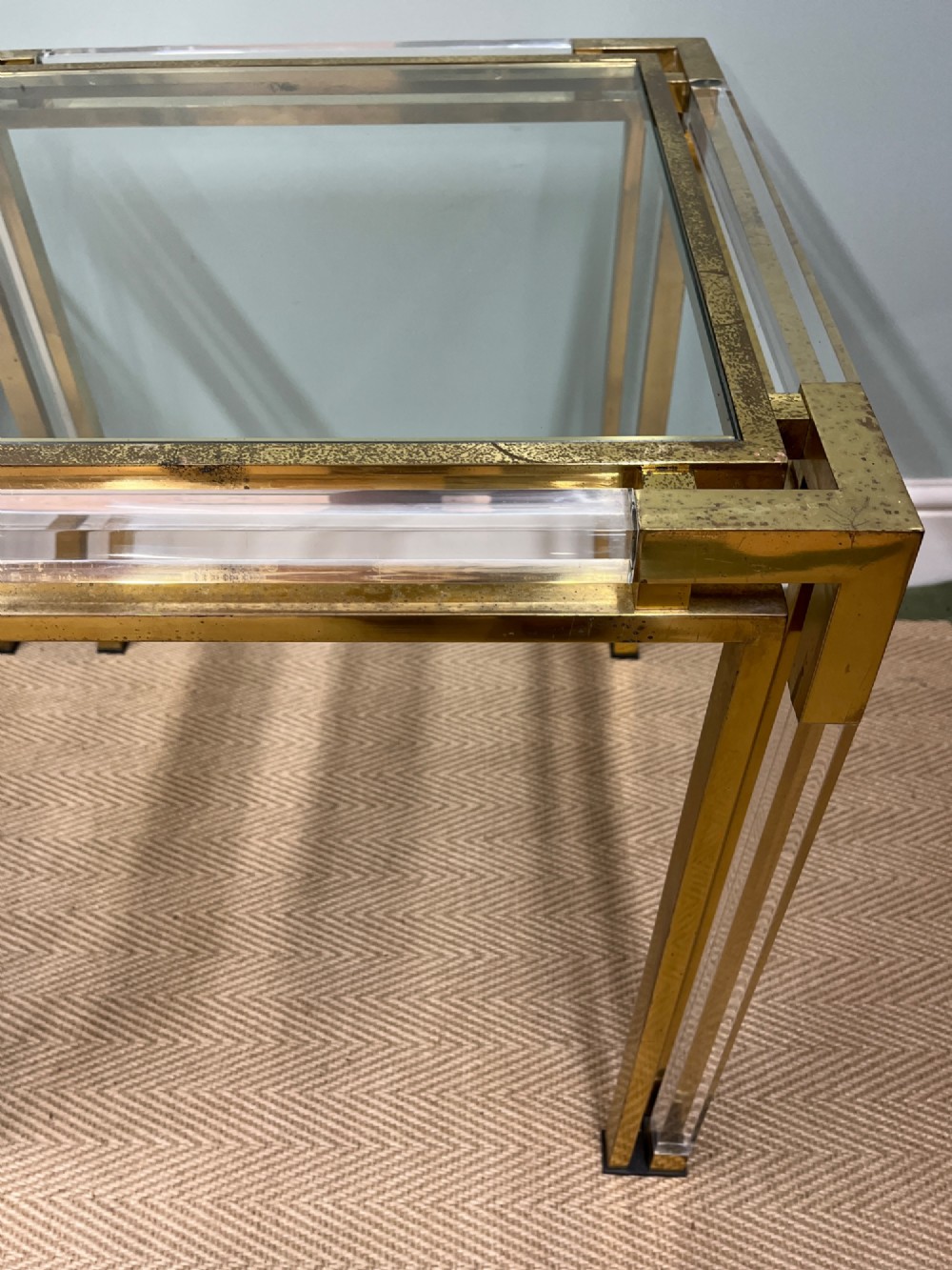A pair of square side tables featuring brass frames, clear lucite corner inserts, and glass tops. View IV