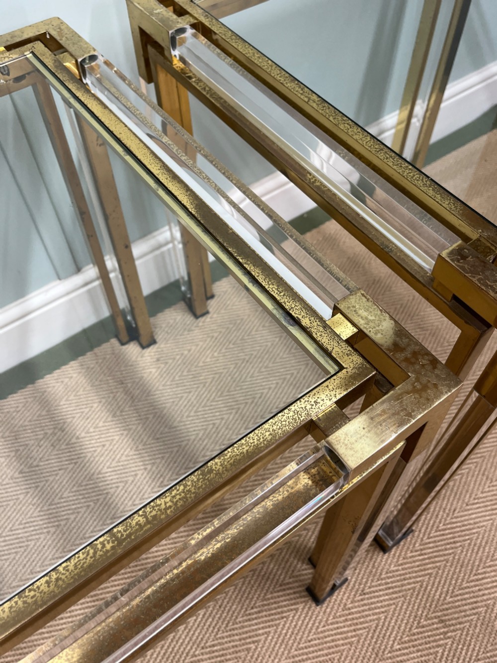 A pair of square side tables featuring brass frames, clear lucite corner inserts, and glass tops. View V