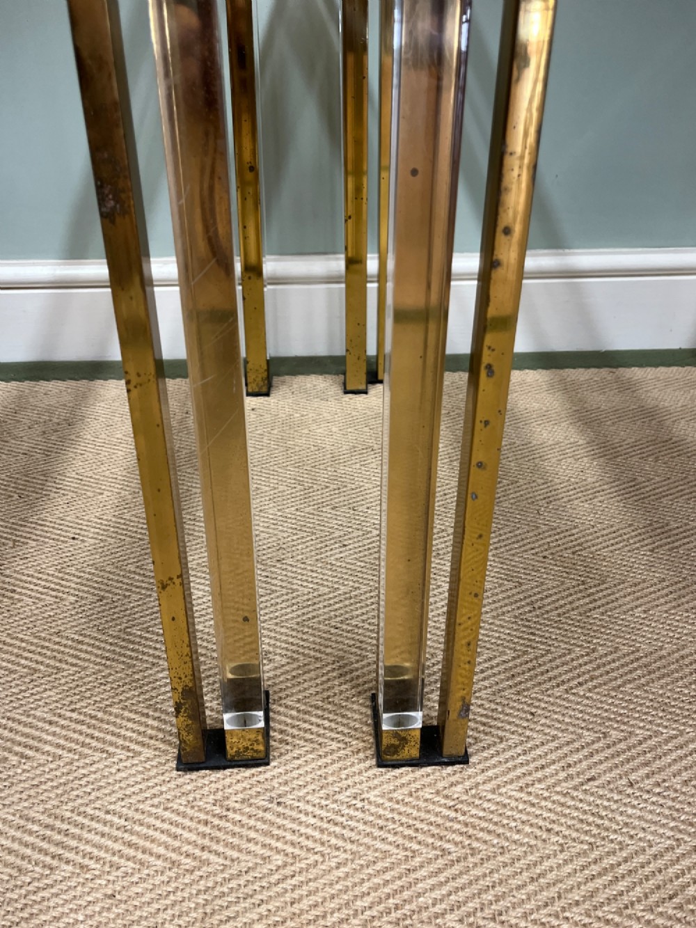 A pair of square side tables featuring brass frames, clear lucite corner inserts, and glass tops. View VI